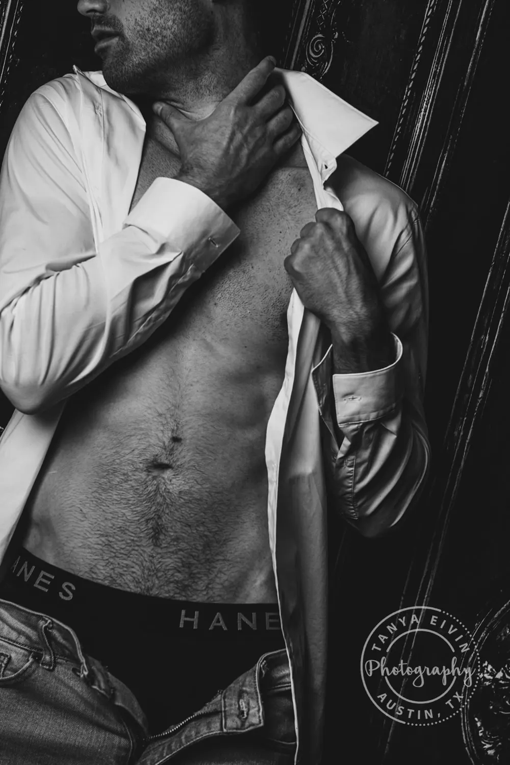 a groom in a white shirt at a boudoir session